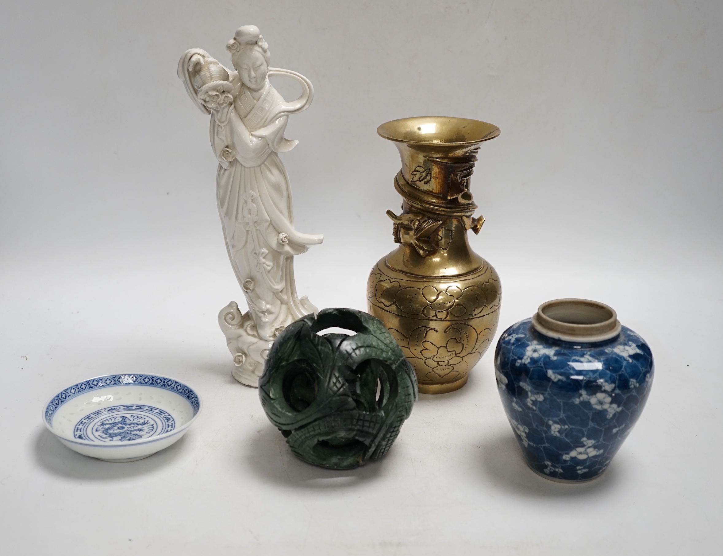 A Chinese blanc de chine model of Guanyin, a bronze vase, a hardstone concentric ball, a blue jar and dish (5), tallest 25cm